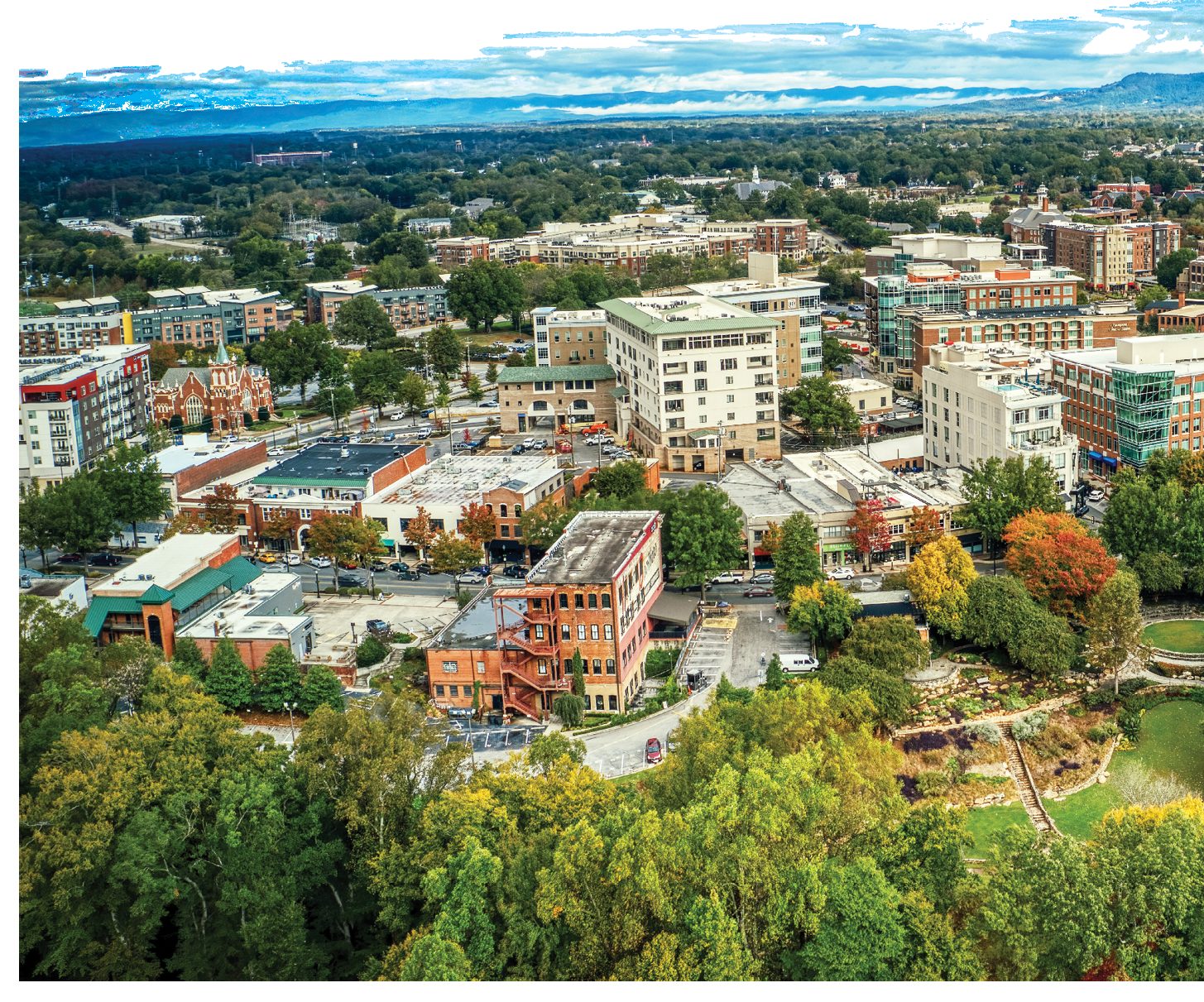 Aerial view of downtown Greenville, South Carolina, with mountains on the horizon