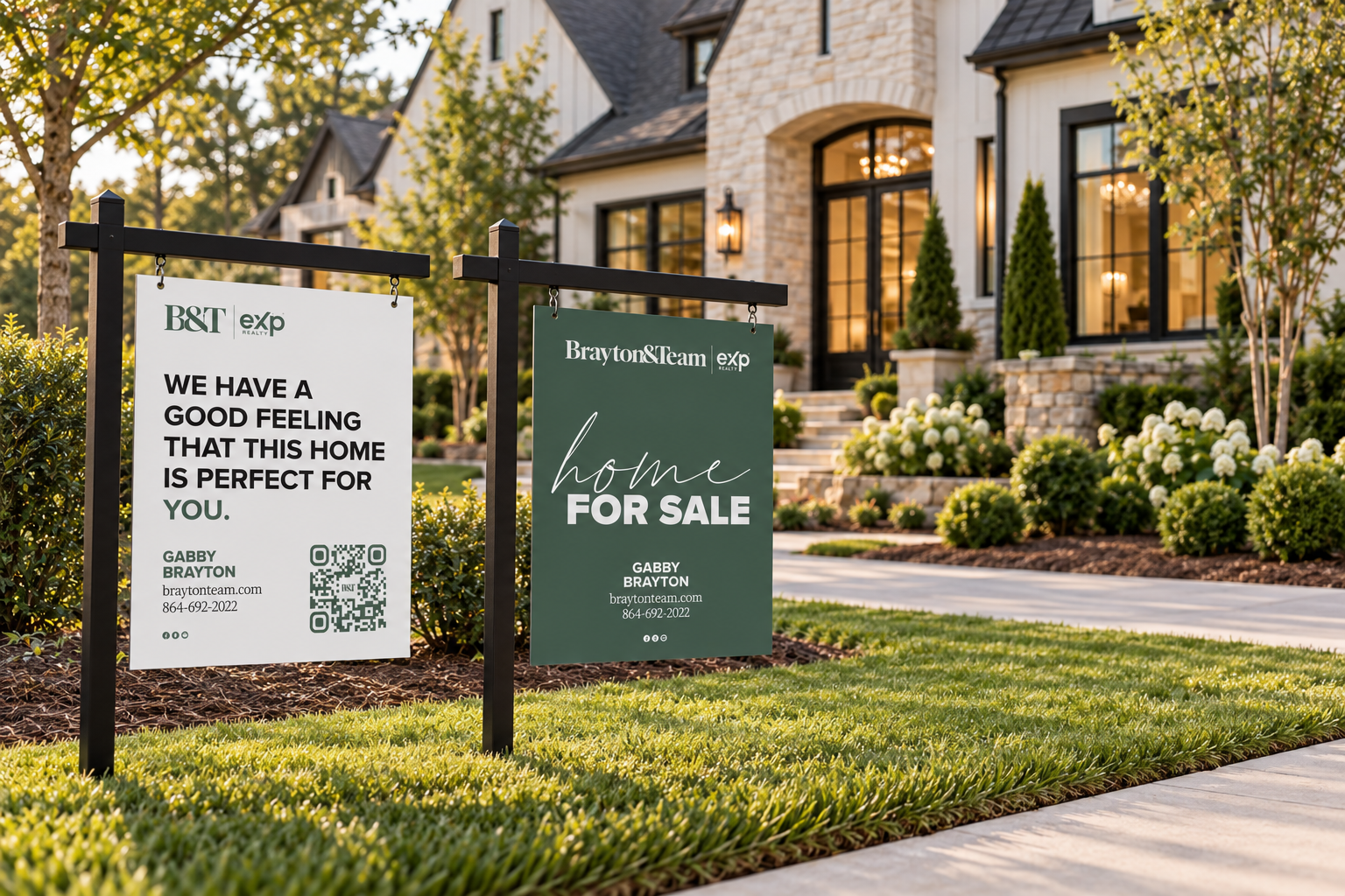 Two Brayton & Team yard signs in front of a stone farmhouse, the green Home for Sale sign and the white We have a good feeling sign with Gabby Brayton's contact details and QR code