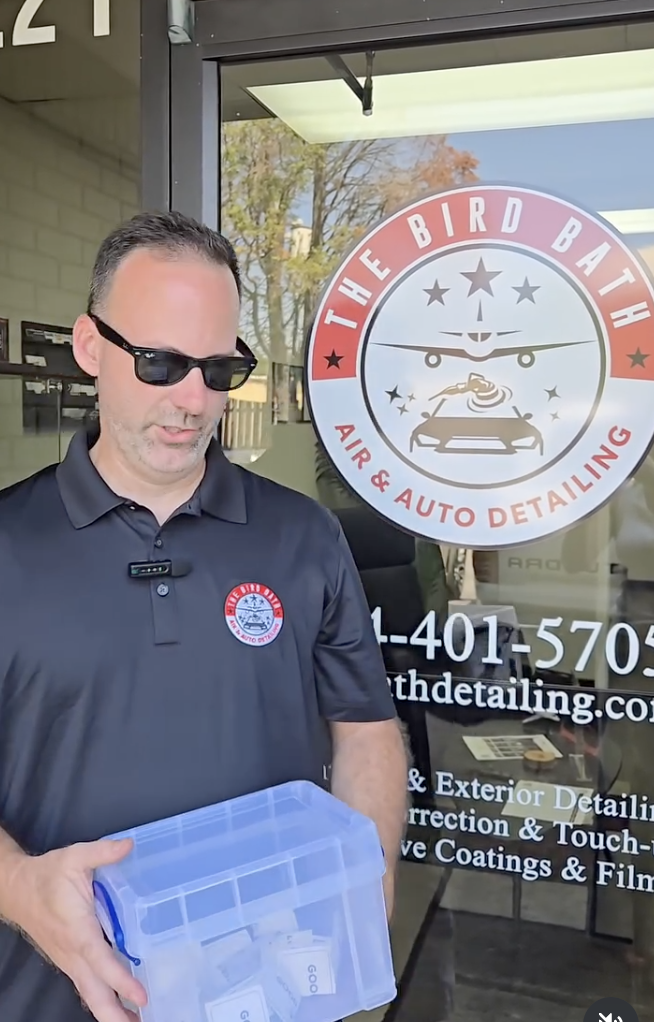 Tyler Parrot of Bird Bath Detailing at his shop entrance